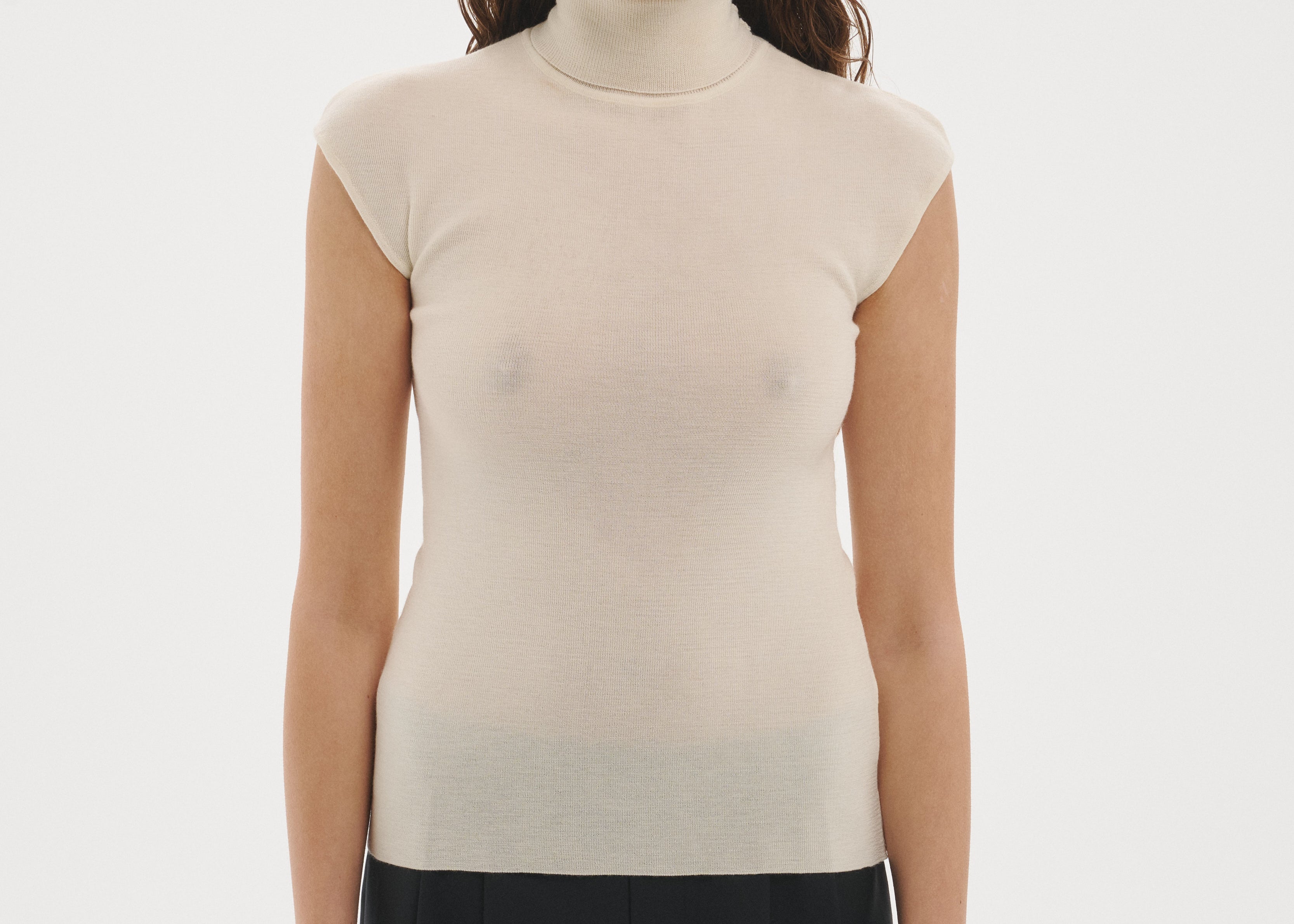Şener Besim Merino Cap Sleeve Top in White, styled with black wide-leg trousers