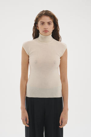 Şener Besim Merino Cap Sleeve Top in White, styled with black wide-leg trousers