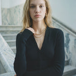 Black merino wool button cropped cardigan, front view — Şener Besim