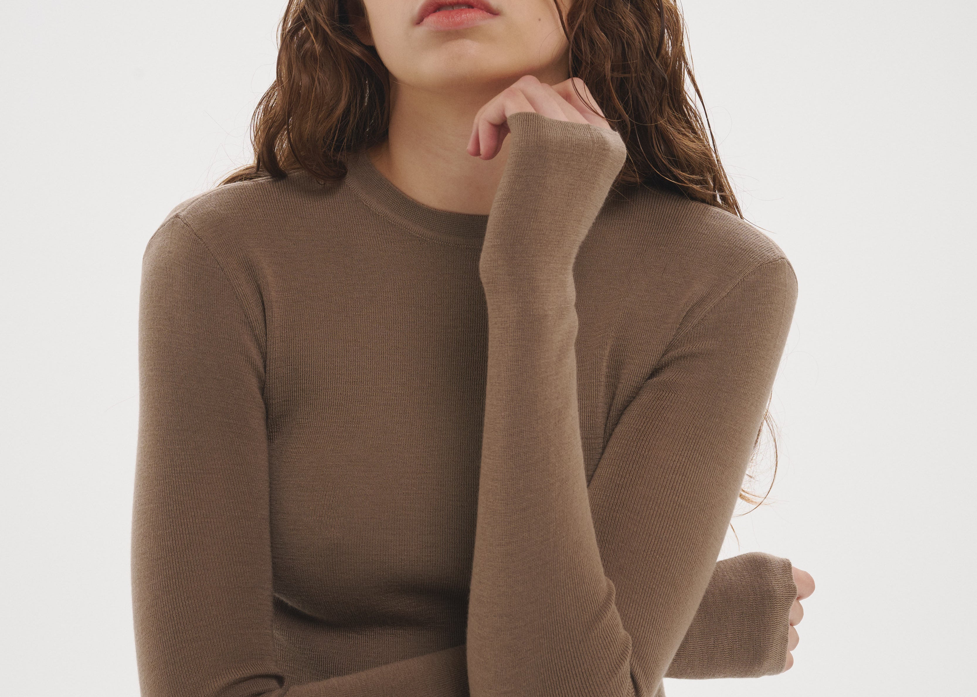 Şener Besim Merino Thumbhole Crewneck in Putty, editorial showing the thumbhole cuff