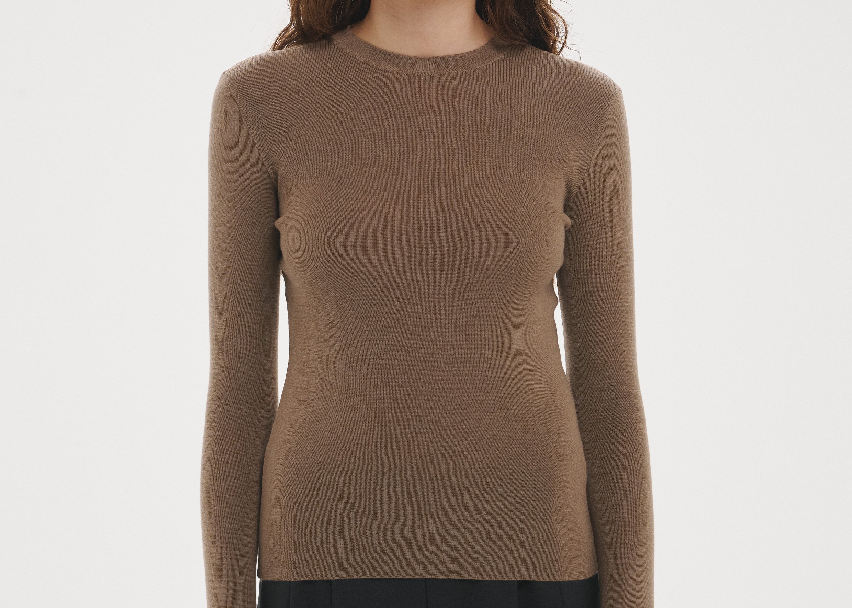 Şener Besim Merino Thumbhole Crewneck in Putty, styled with black wide-leg trousers