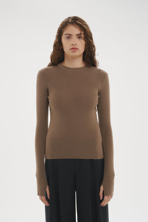 Şener Besim Merino Thumbhole Crewneck in Putty, styled with black wide-leg trousers