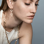 Şener Besim Mosaic Long Earring gold worn on ear, geometric chain links, editorial shot