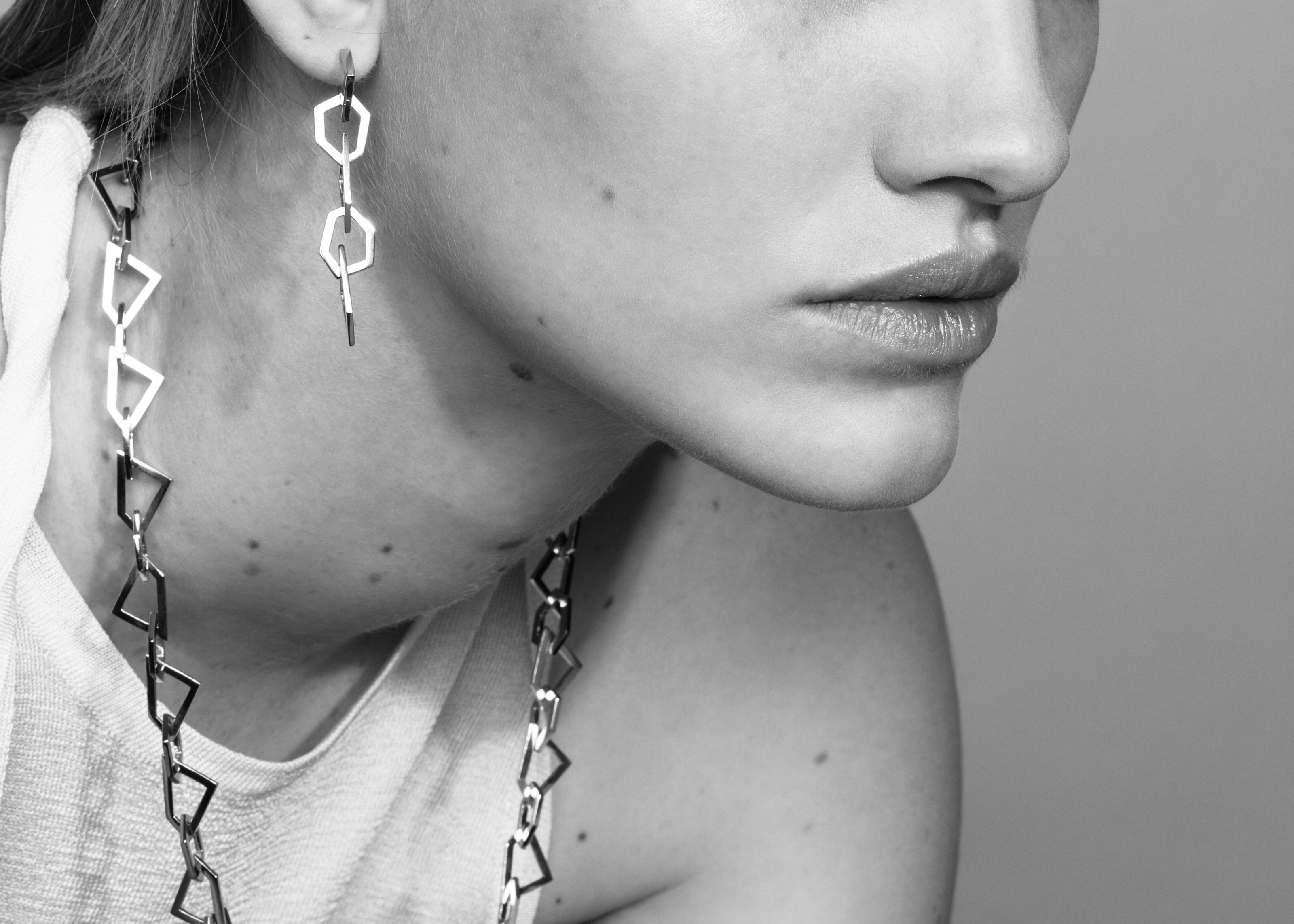 Şener Besim Mosaic Long Earring silver worn on ear, geometric chain links, editorial shot