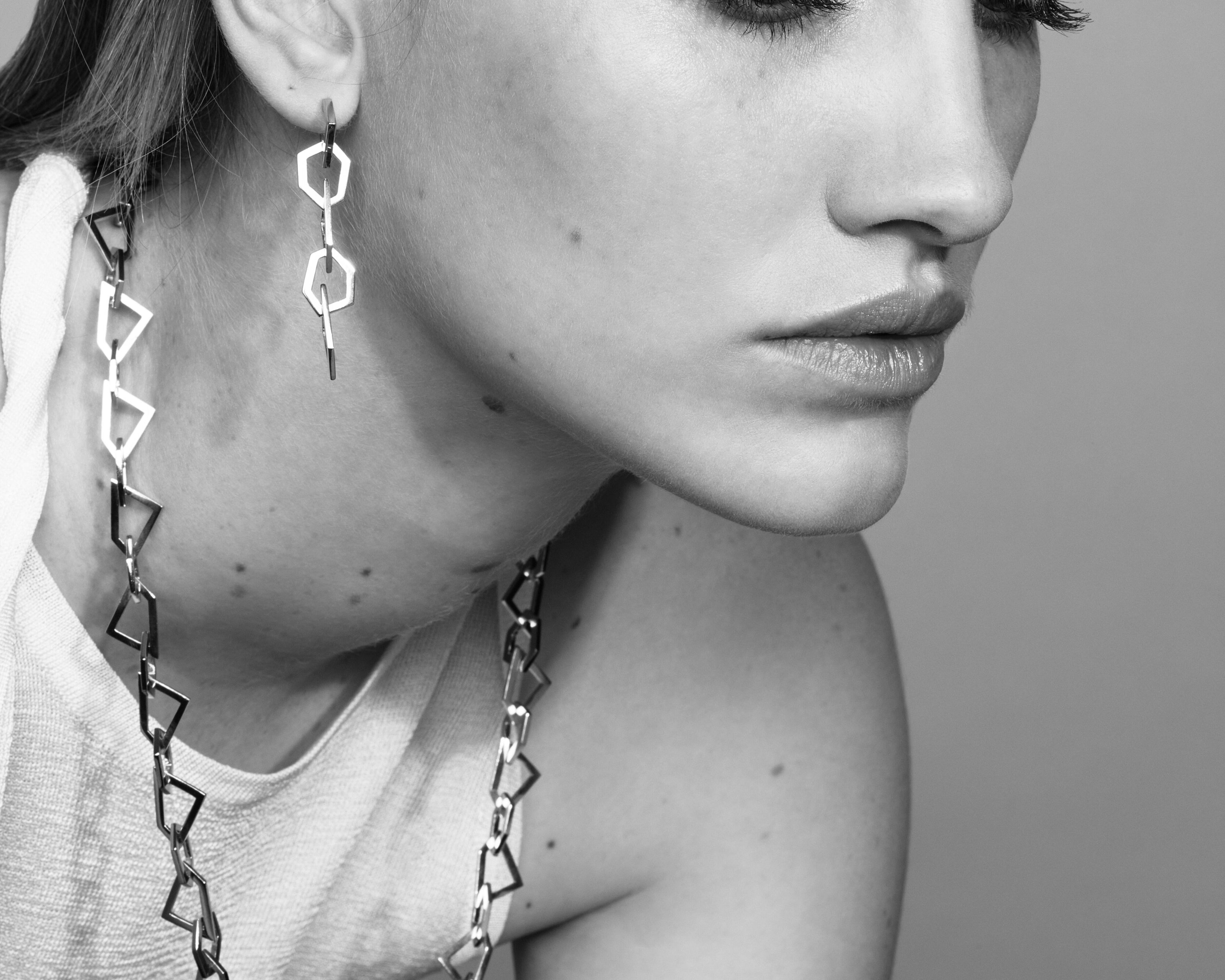Şener Besim Mosaic Long Earring silver worn on ear, geometric chain links, editorial shot