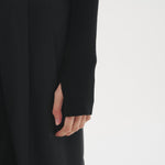 Close-up of the Şener Besim Multibutton Cardi in Black sleeve and knit detail