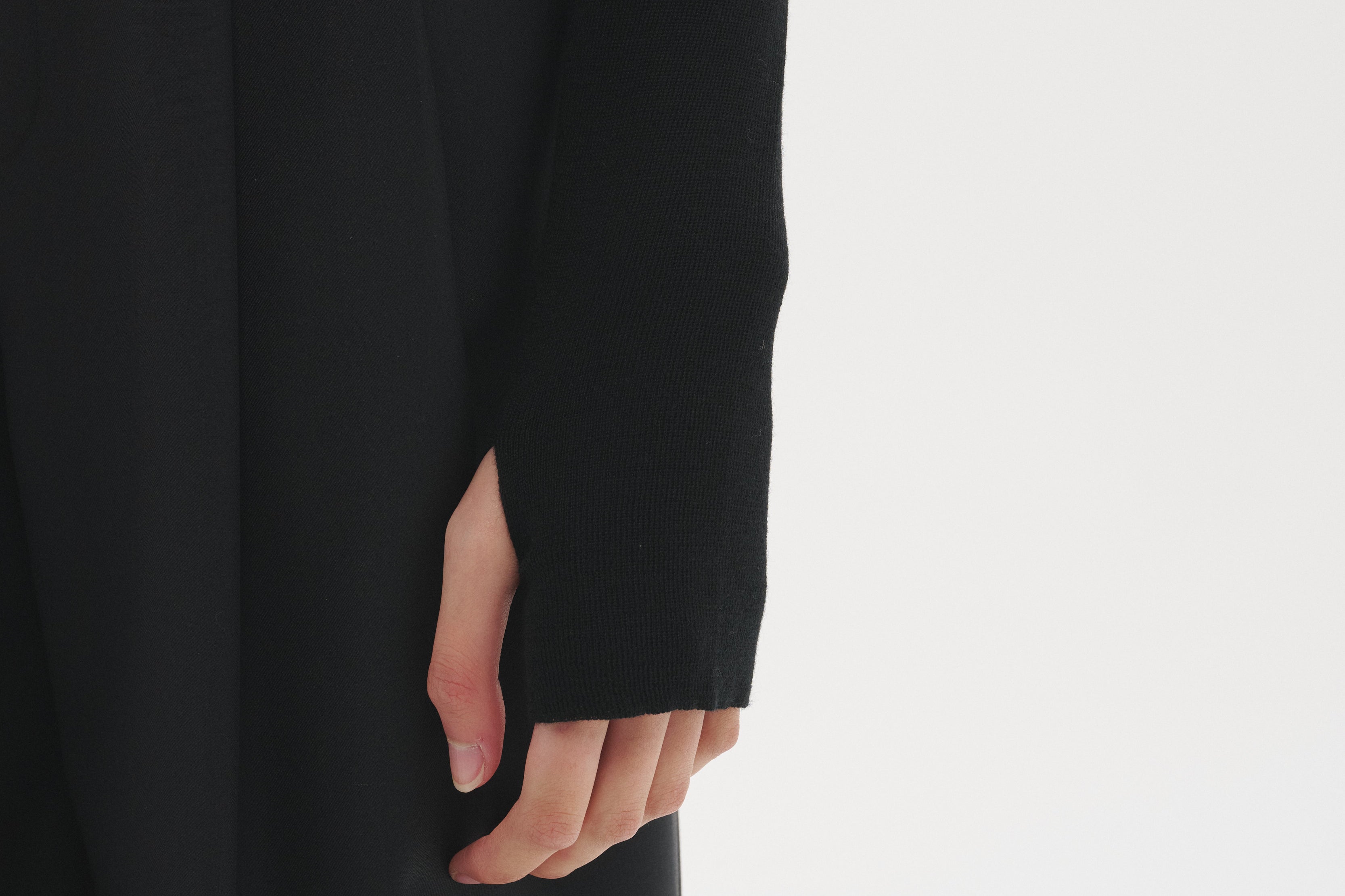 Close-up of the Şener Besim Multibutton Cardi in Black sleeve and knit detail