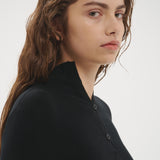 Şener Besim Multibutton Cardi in Black worn close-fitted, portrait view