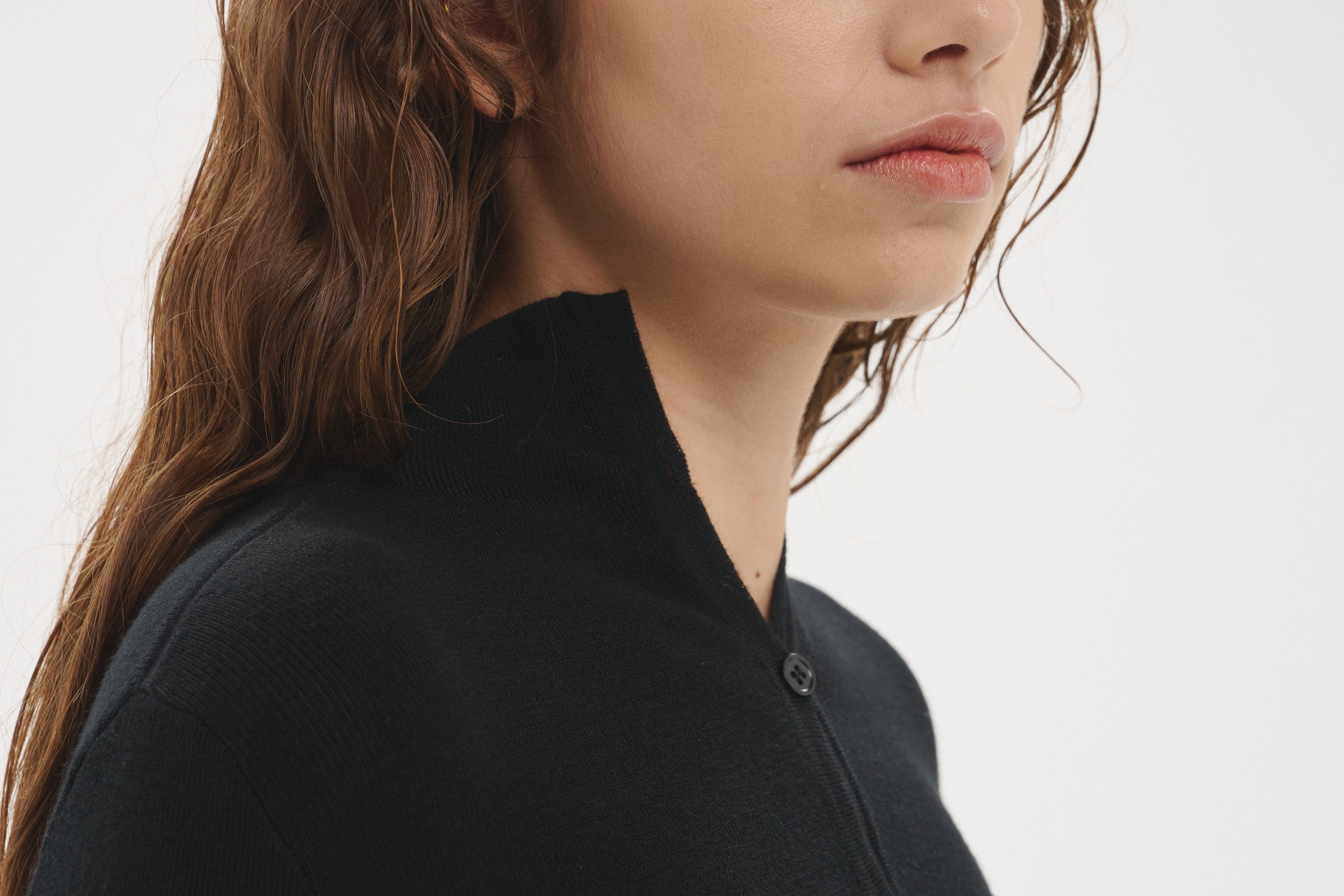 Şener Besim Multibutton Cardi in Black worn close-fitted, portrait view