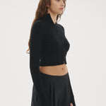 Şener Besim Multibutton Cardi in Black, side profile showing the fitted silhouette