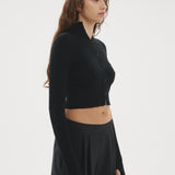 Şener Besim Multibutton Cardi in Black, side profile showing the fitted silhouette