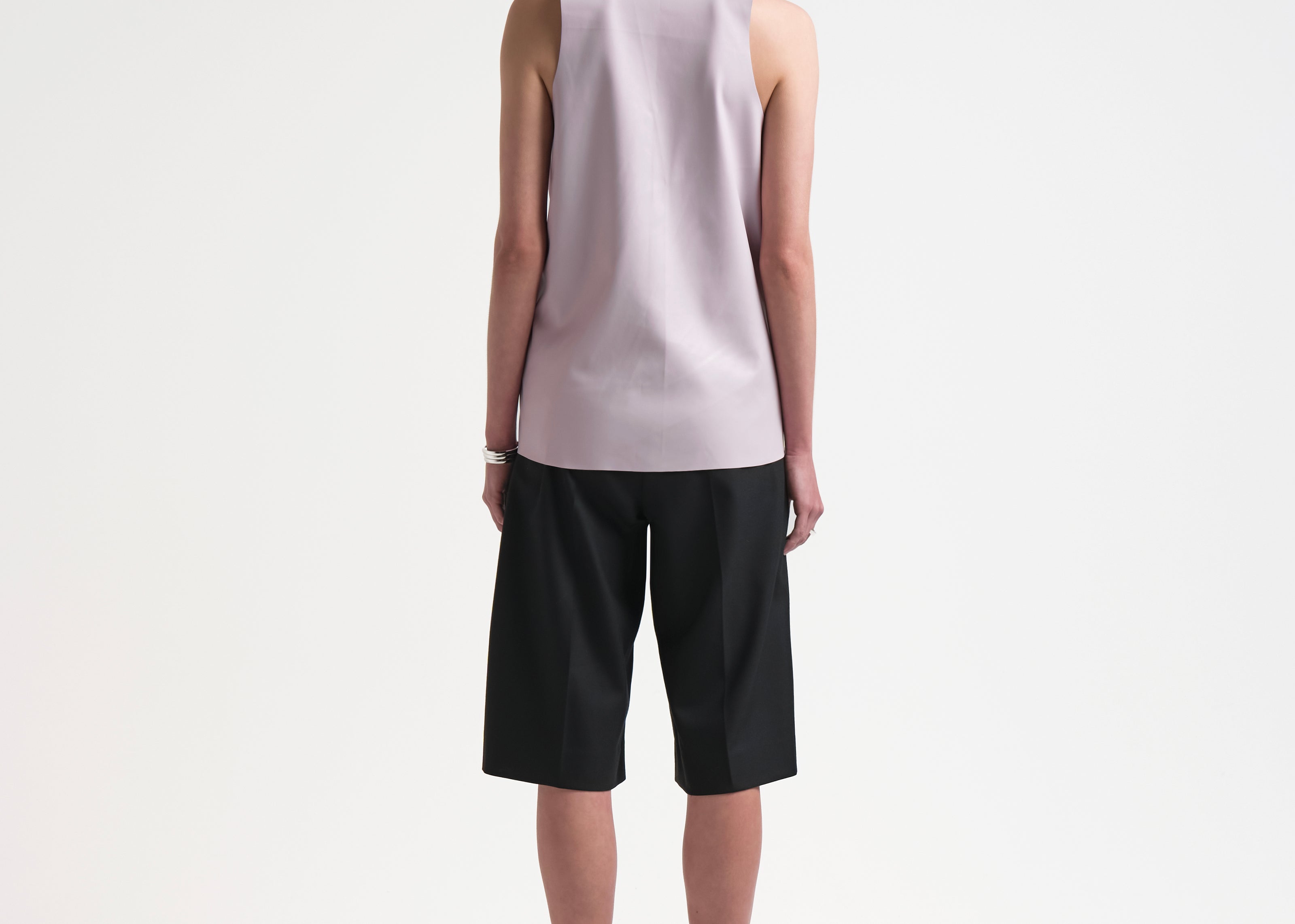 back of model wearing pink vegan leather tank by sener besim