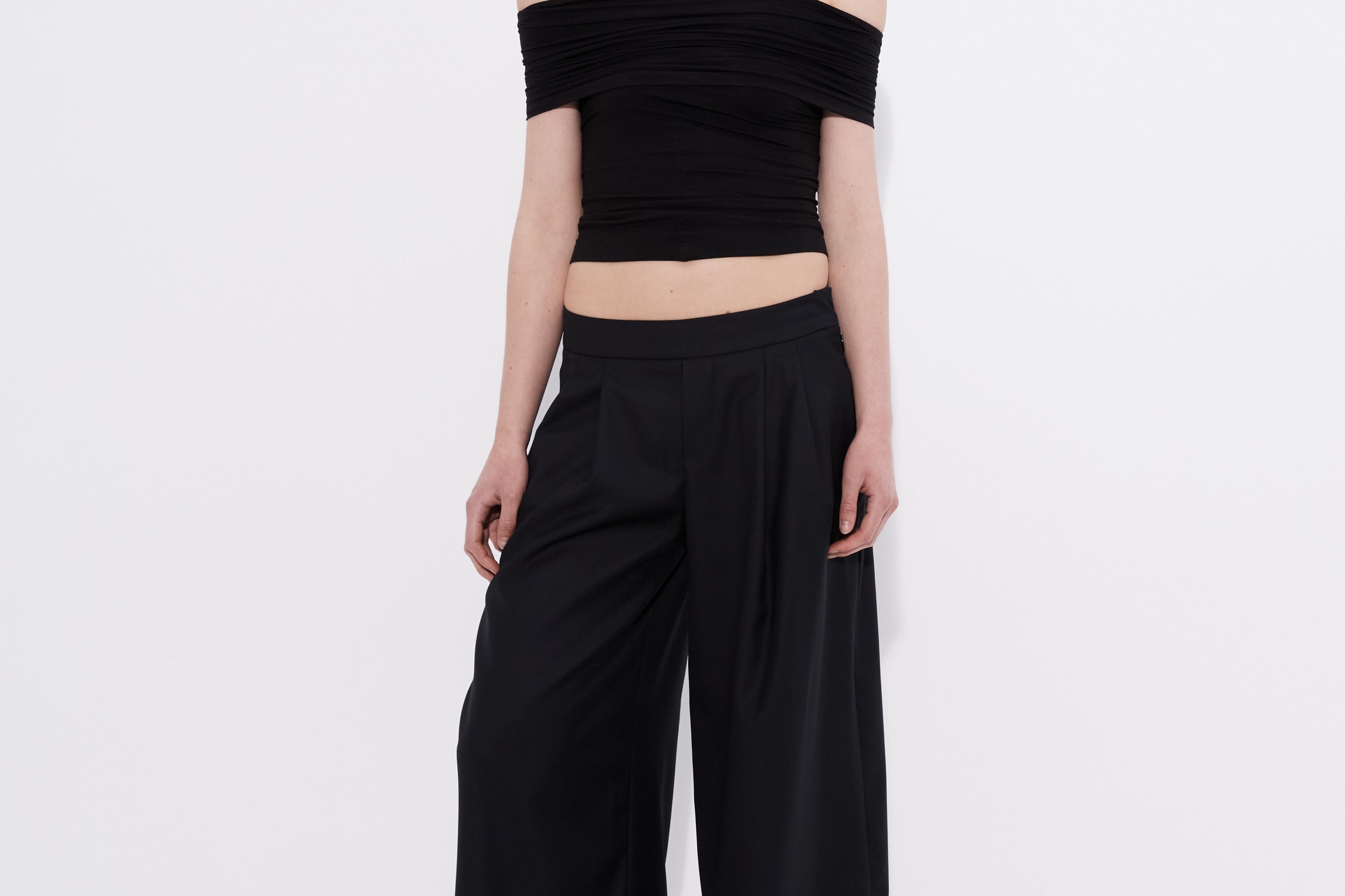 Şener Besim black off shoulder top styled with wide leg pants
