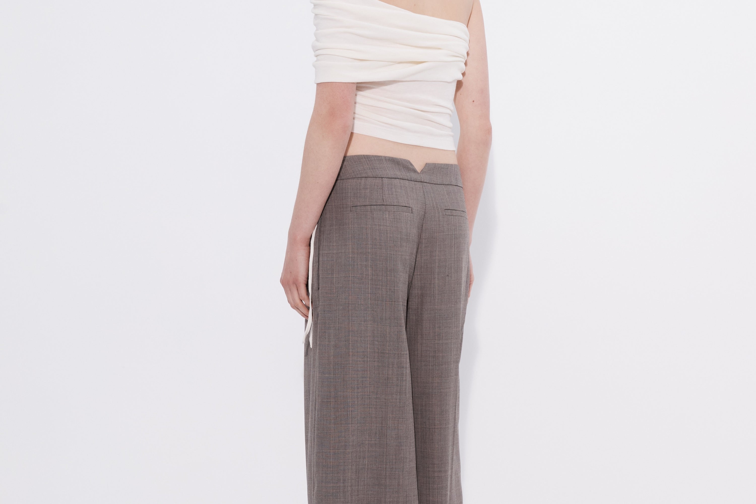 Şener Besim white off shoulder top styled with wide leg trousers