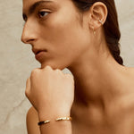 gold and silver cuff bracelet worn on model by sener besim