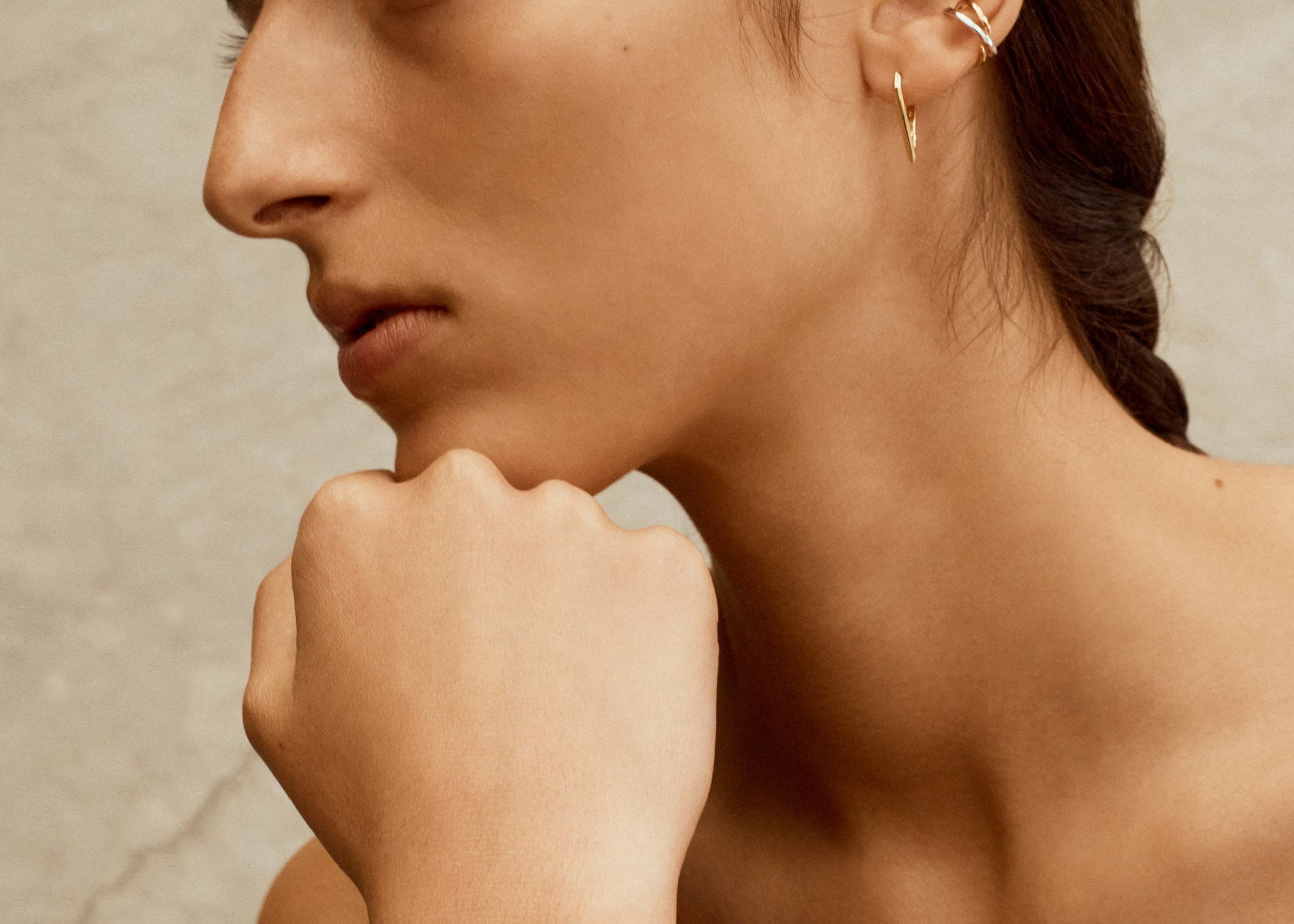 gold and silver cuff bracelet worn on model by sener besim