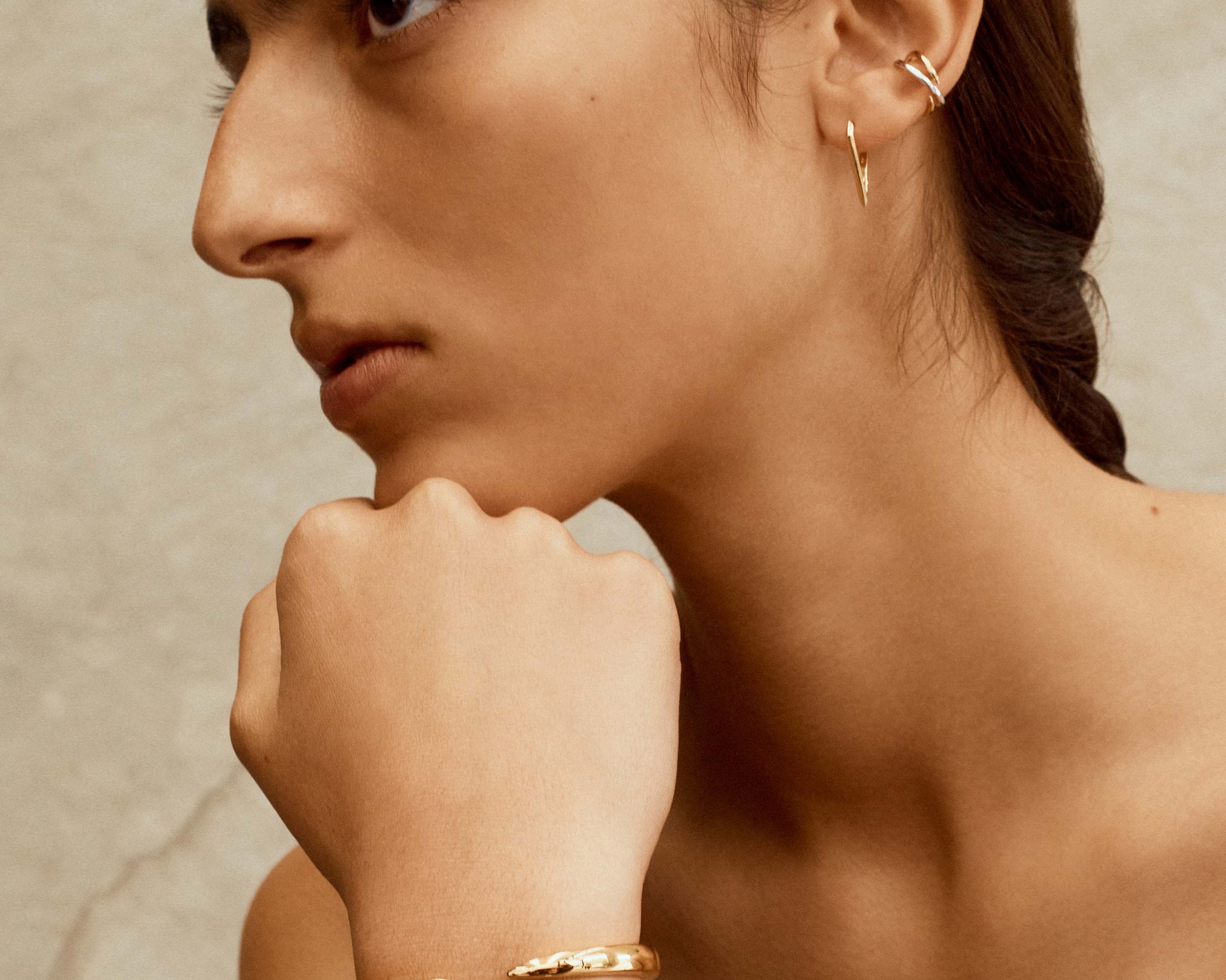 gold and silver cuff bracelet worn on model by sener besim