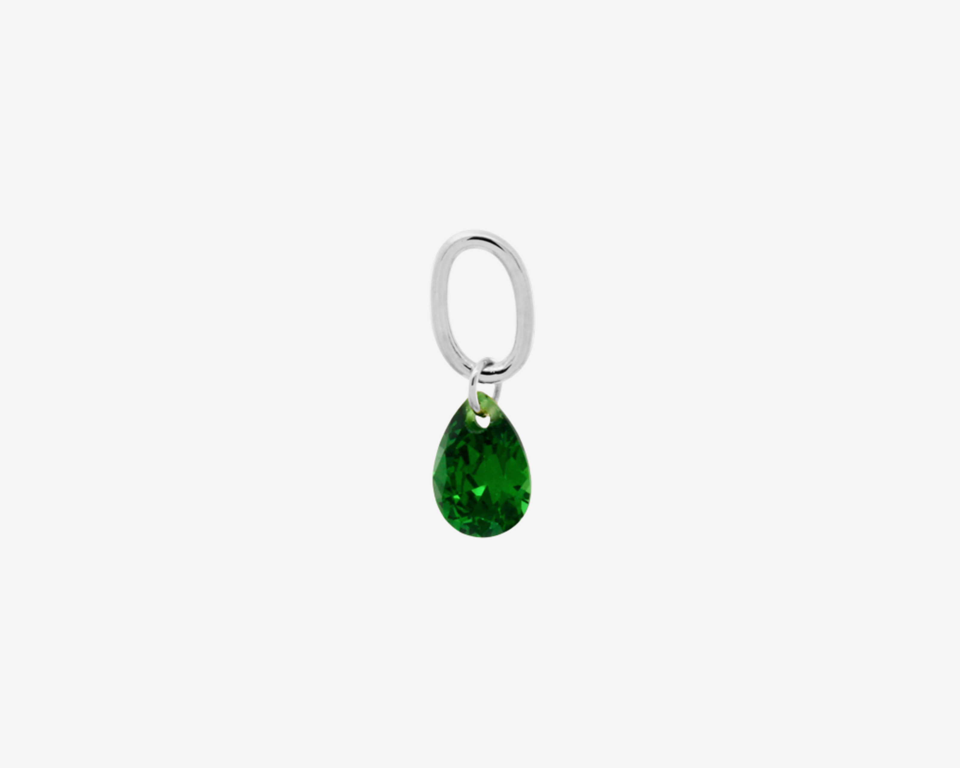 Şener Besim Teardrop Charm with emerald cubic zirconia in rhodium plating, flat lay