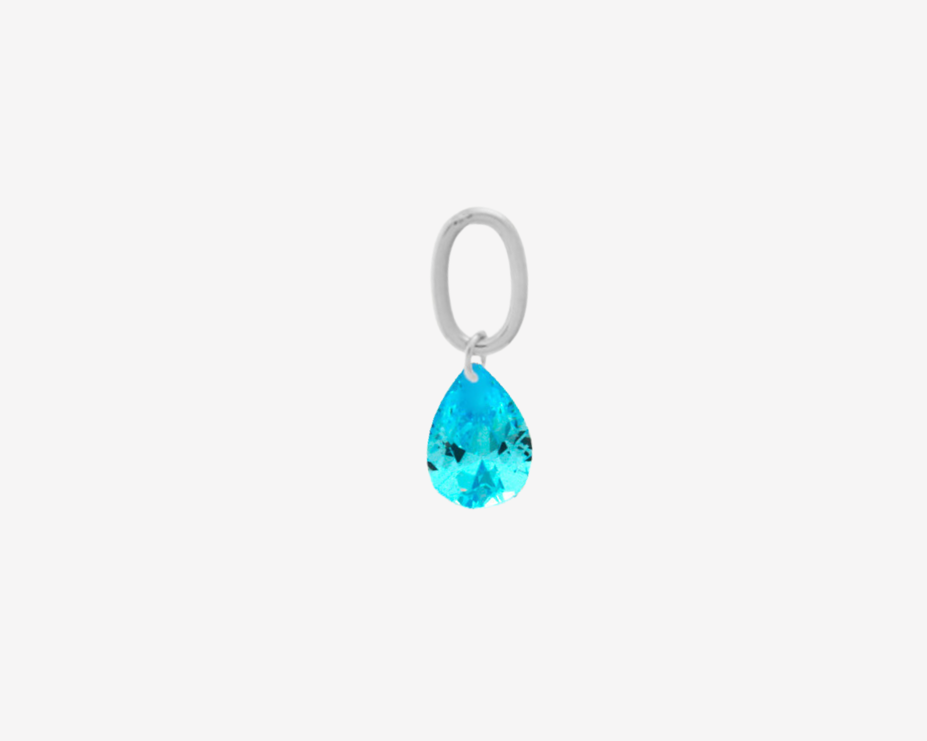 Teardrop Charm Light Blue Silver by Şener Besim in sterling silver with rhodium plating, set with a faceted light blue cubic zirconia