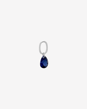 Şener Besim Teardrop Charm with sapphire cubic zirconia in rhodium plating, flat lay