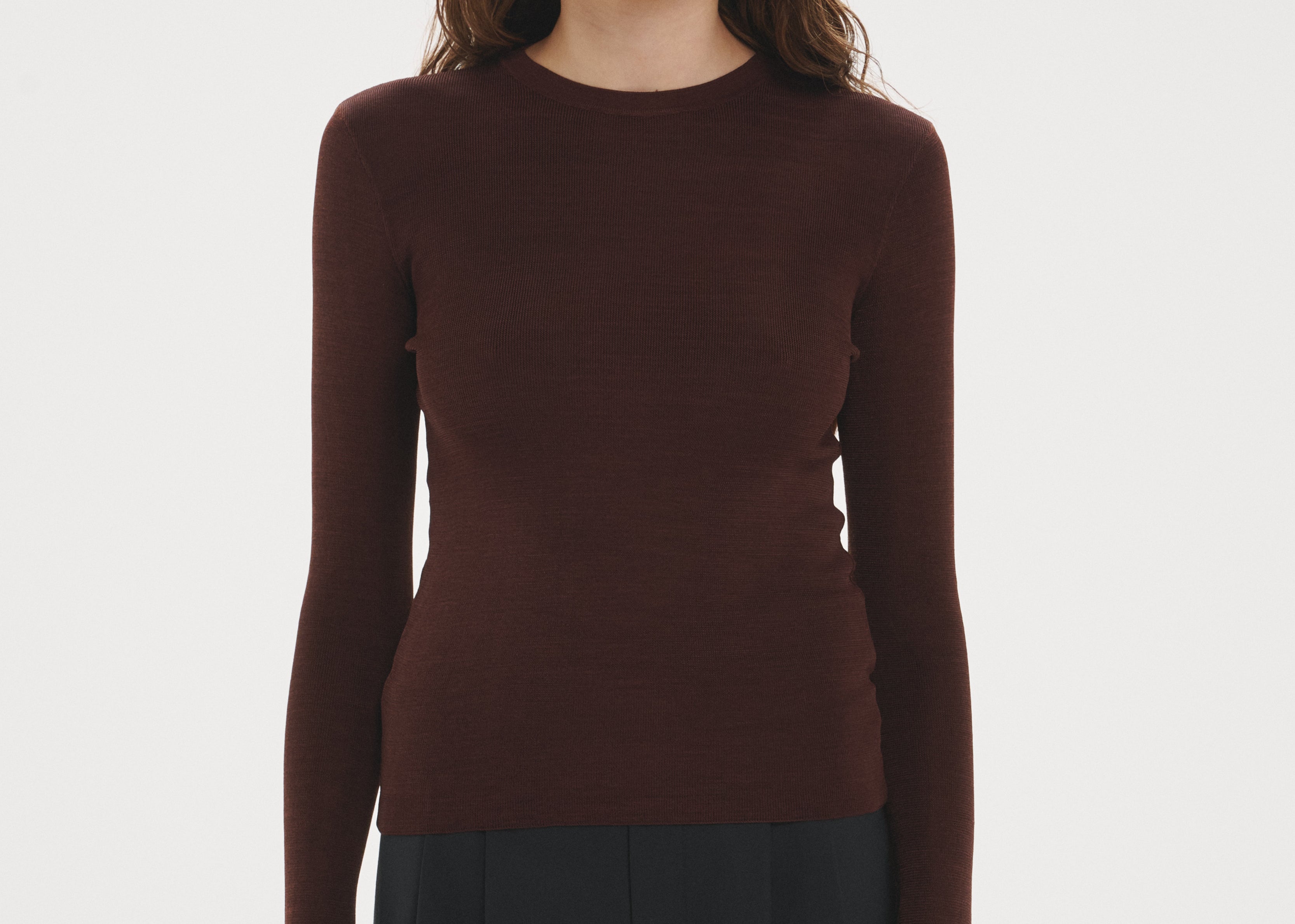 Şener Besim Thumbhole Crewneck in Chocolate, styled with black wide-leg trousers