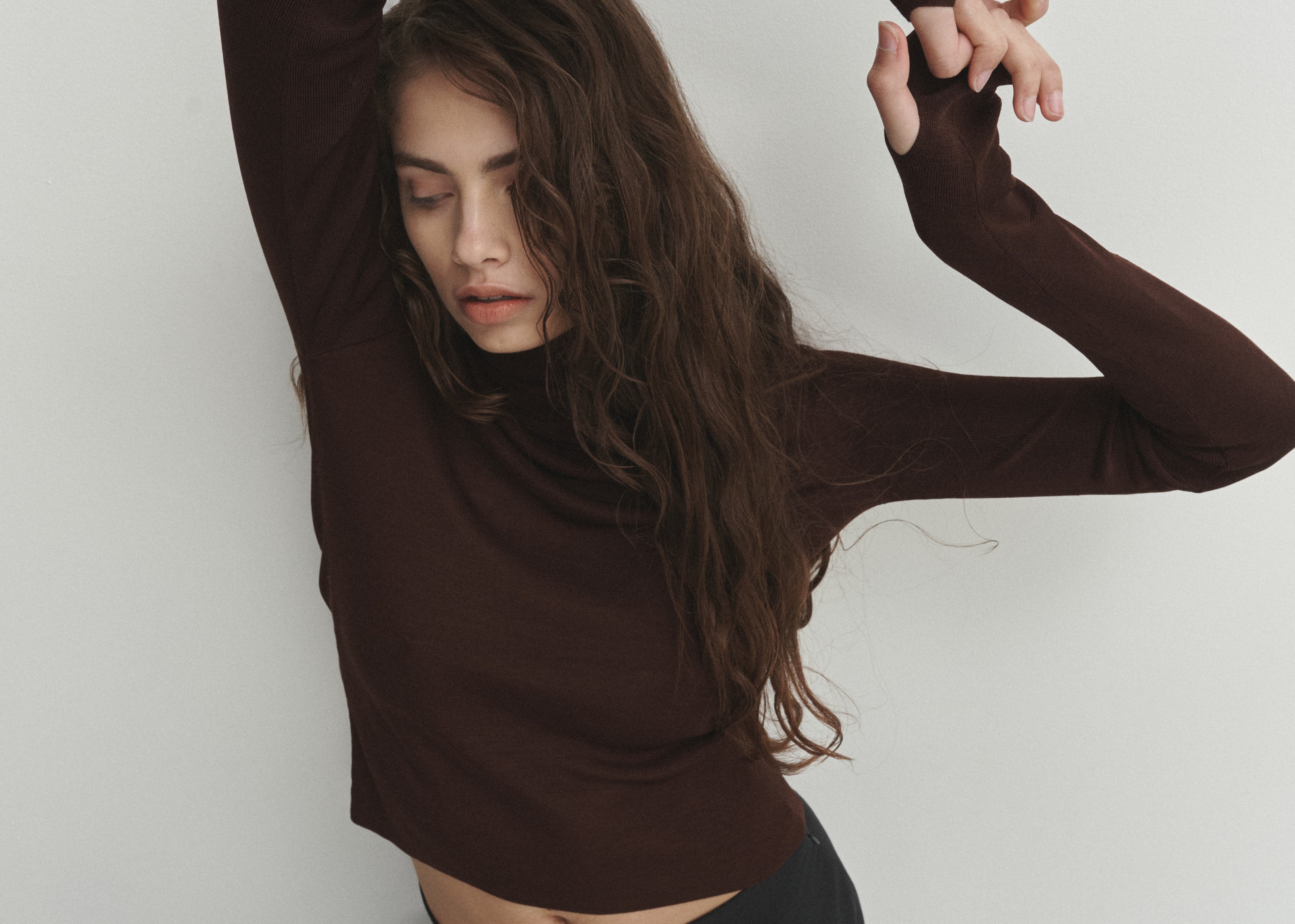 Şener Besim Thumbhole Turtleneck in Chocolate, styled with black wide-leg trousers