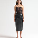 Model wearing a black sheer camisole top by sener besim