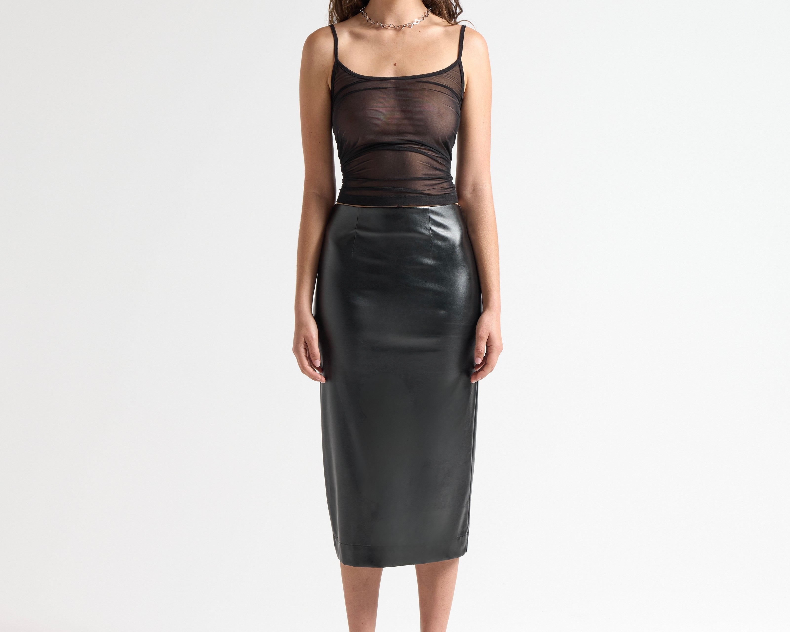 Model wearing a black sheer camisole top by sener besim