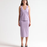 woman wearing a light purple sleeveless leather tank by sener besim