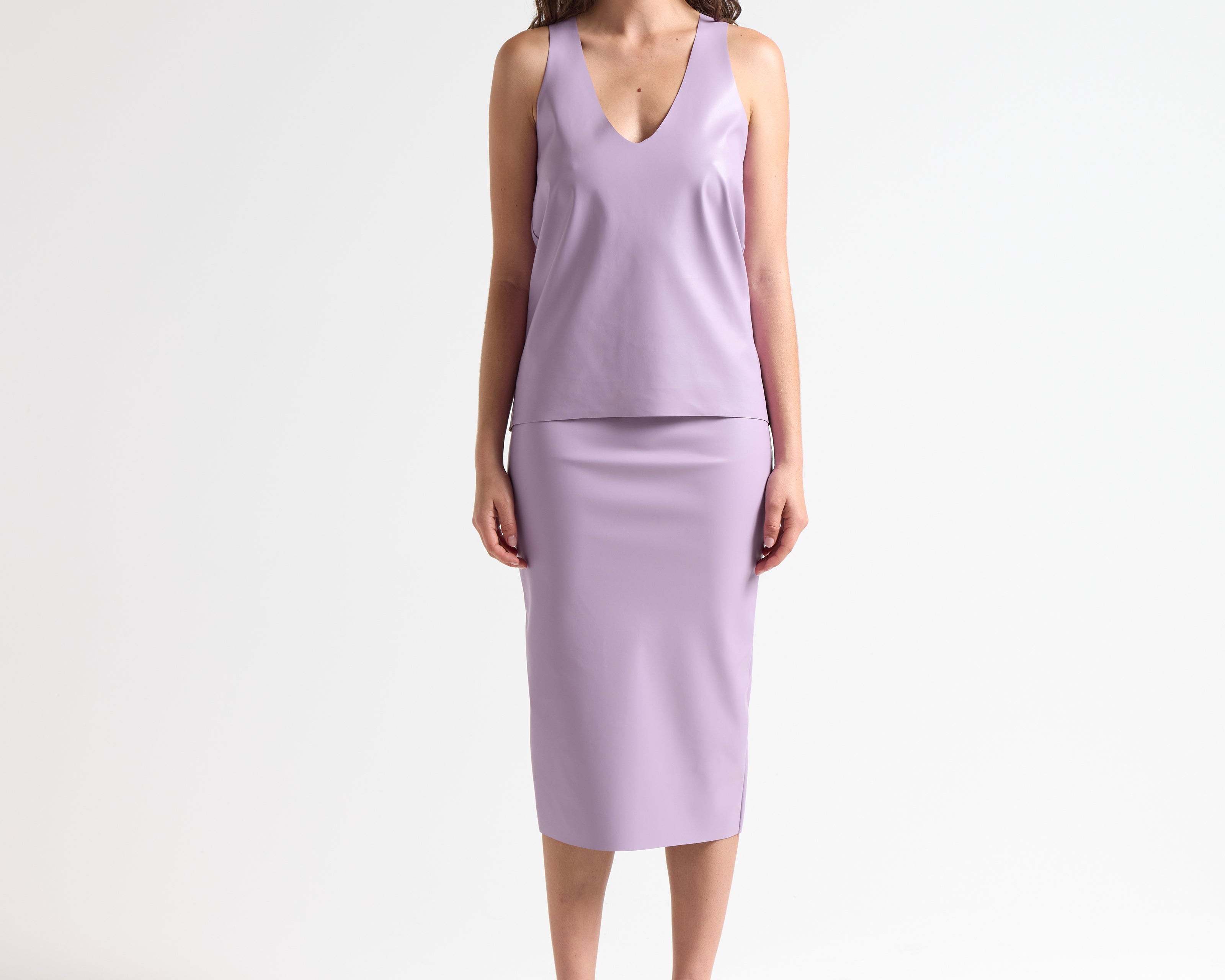 woman wearing a light purple sleeveless leather tank by sener besim