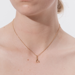 Şener Besim Wishbone Charm worn on necklace — sterling silver