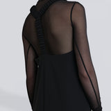 Model wearing Şener Besim Y Back Dress in black, midi length