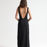 model wearing black open back dress with full length by sener besim