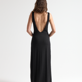 model wearing black open back dress with full length by sener besim