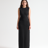 model wearing a black sleeveless long dress by sener besim