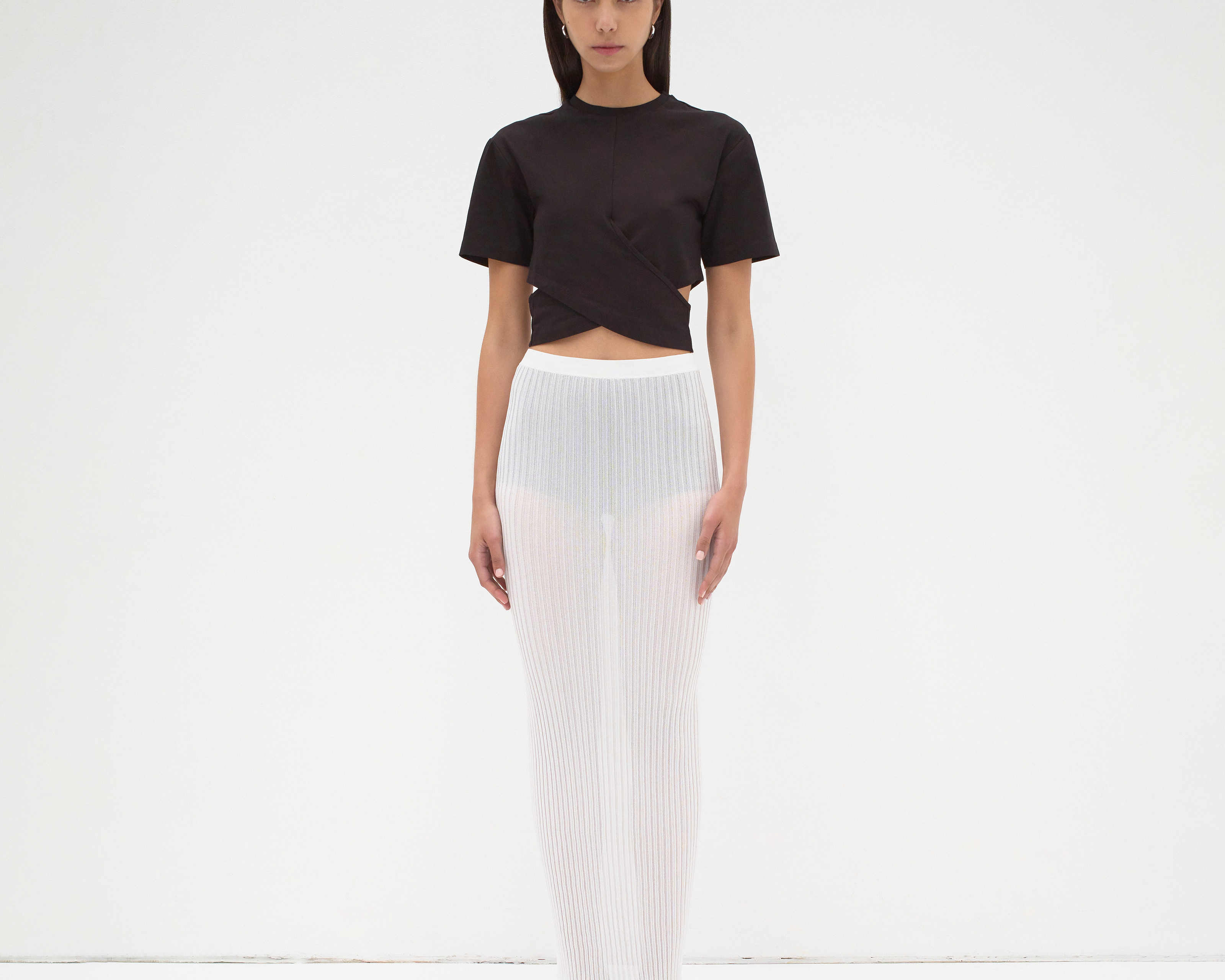A model wearing a black cropped wrap tee by sener besim