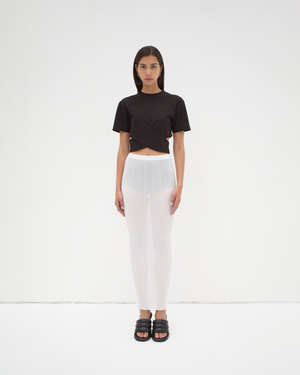 A model wearing a black cropped wrap tee by sener besim