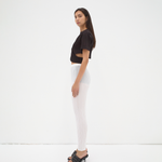 model wearing cropped tee with cut out detail in black by sener besim
