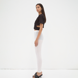 model wearing cropped tee with cut out detail in black by sener besim