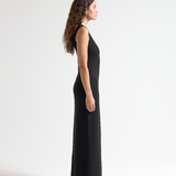 side view of model wearing sener besim long sleeveless simple dress