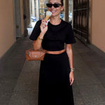 Black maxi skirt styled with crop tee, street style front view