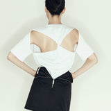 model wearing mini pencil skirt by sener besim featuring zip detail at back