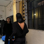 model wearing relaxed boxy shirt by sener besim with open back