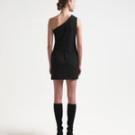 model in sener besim one shoulder asymmetric dress in black with mini length