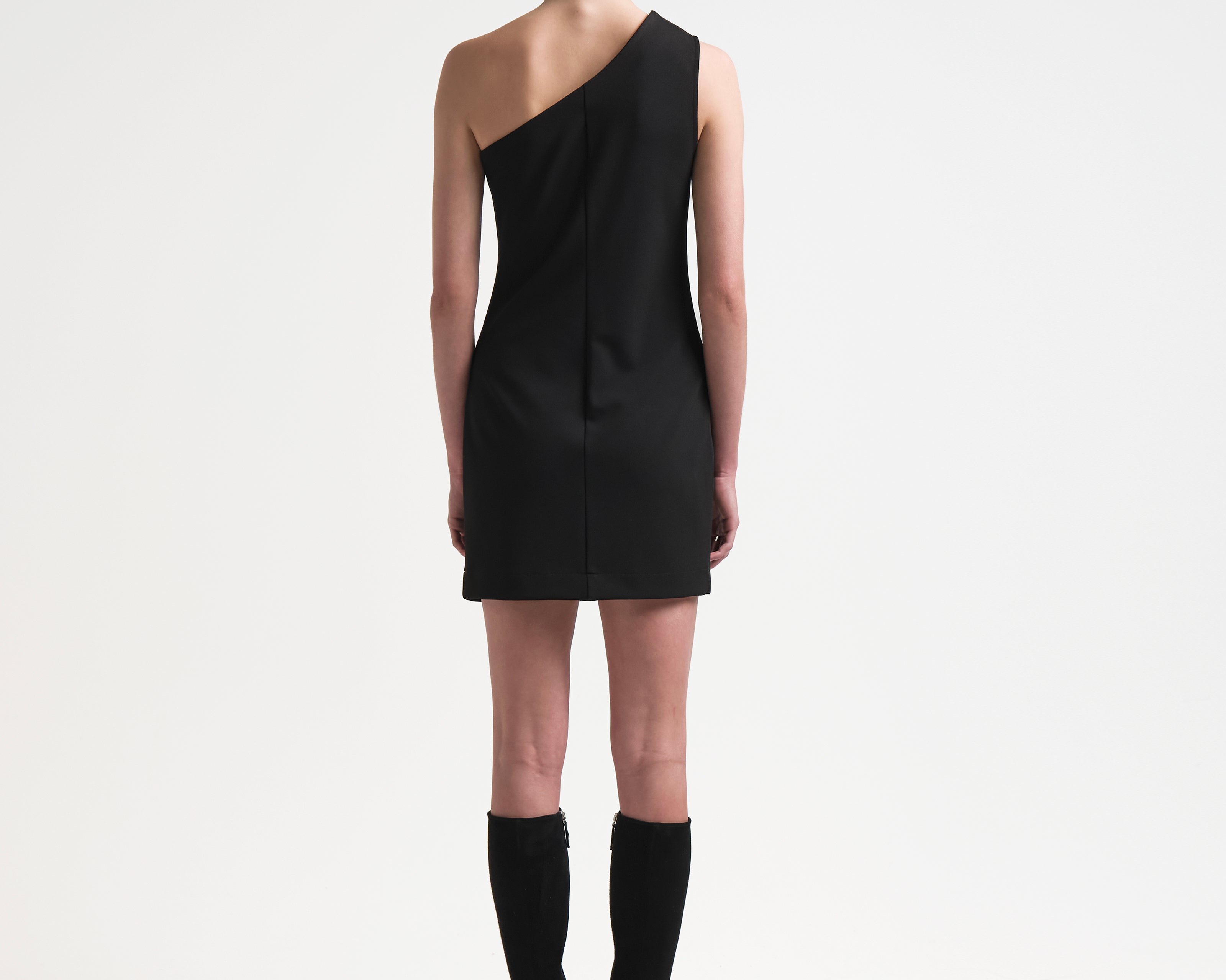 model in sener besim one shoulder asymmetric dress in black with mini length