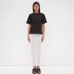 model wearing sener besim tee with boxy shoulders and cut out detail on back