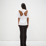 back view of model wearing boxy tee with cut out back detail medium length