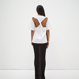 back view of model wearing boxy tee with cut out back detail medium length