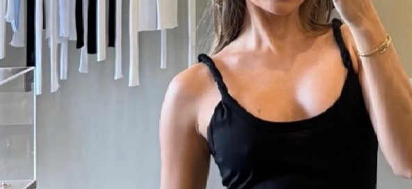 influencer model wearing sener besim twisted strap dress in store