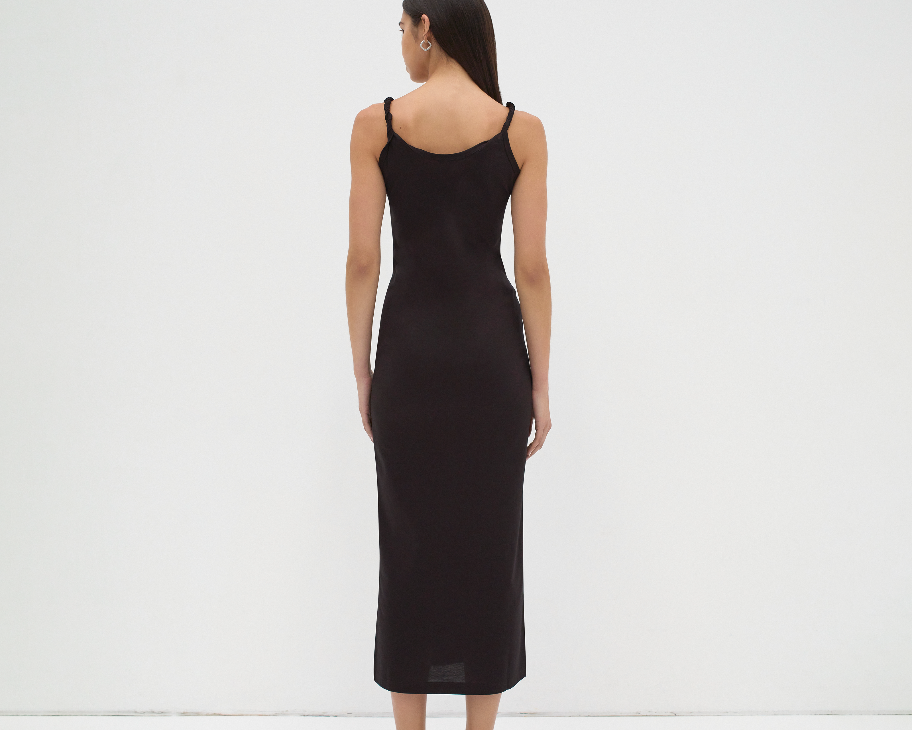 twisted strap singlet slip dress back view on model in black by sener besim